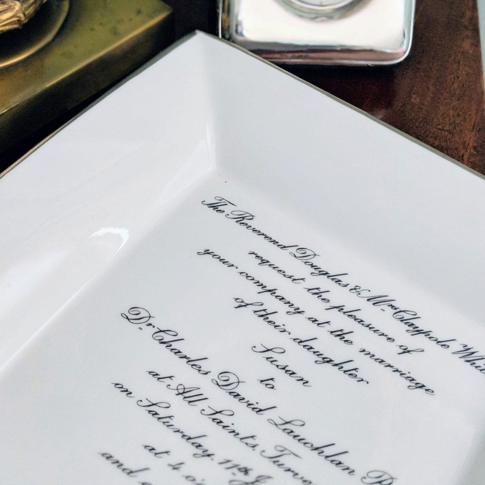 Wedding invitation on a large square dish