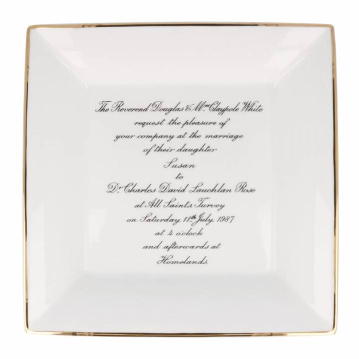 Wedding invitation on a large square dish